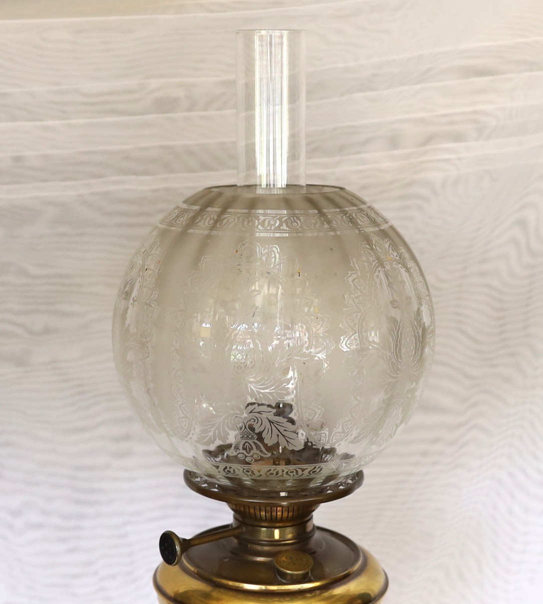 A late Victorian wrought iron brass and copper telescopic oil lamp standard with etched glass shade and flue, height overall 159cm